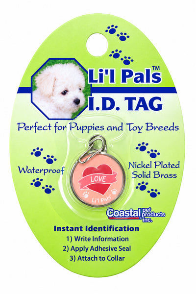 A pink circular dog ID tag with a silver ring, mounted on a light green blister card labeled 'Li'L Pals ID TAG' with product text and a small puppy photo.
